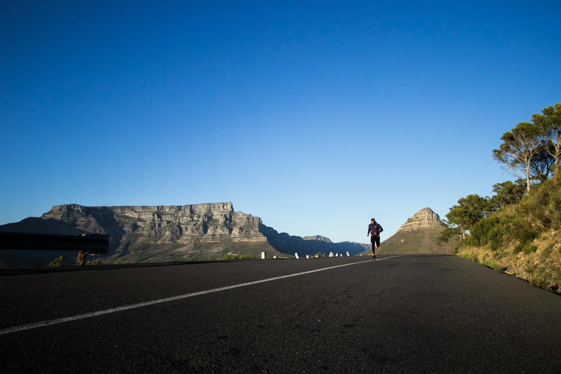 photo of man running during daytime